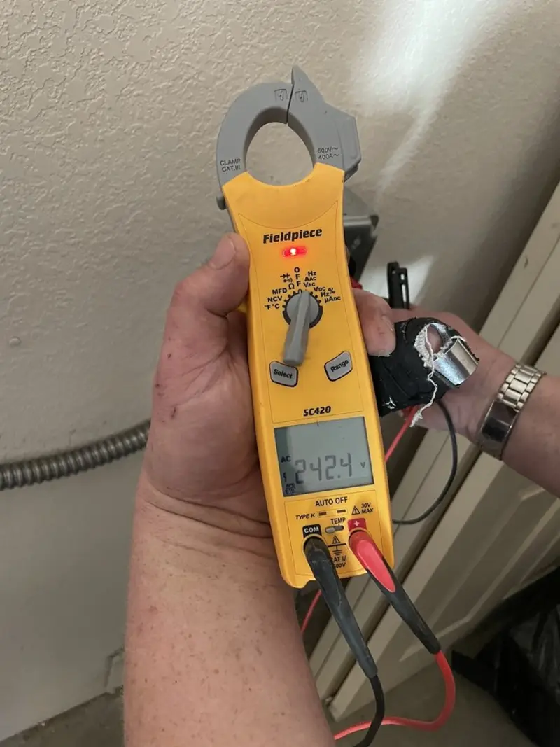 Voltage testing with clamp meter during Ceiling Fan Installation in Hays